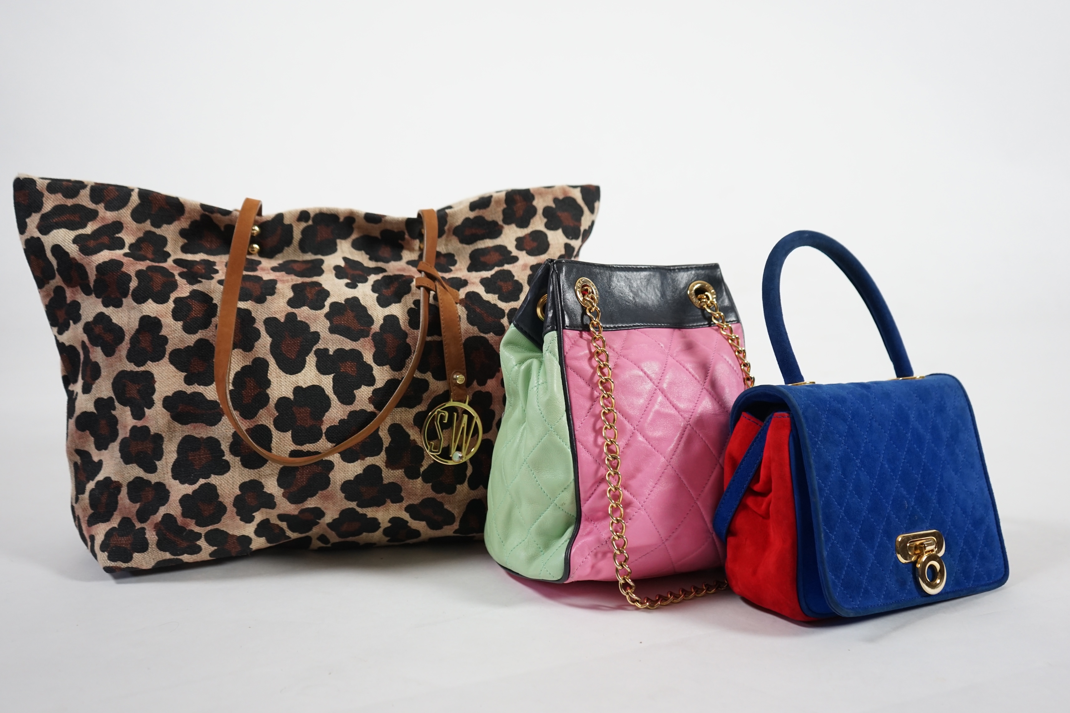 A selection of lady's handbags, including an animal print Stuart Weitzman shoulder bag with dust bag, an Escada suede royal blue and red shoulder bag, and another Escada handbag in navy blue with pink and light green qui